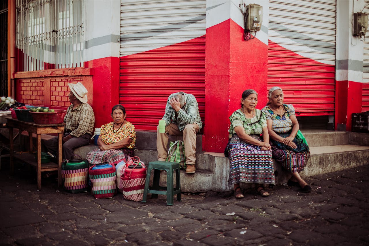 Crafting Captivating Headlines: Your awesome post title goes here Elderly vendors sitting by a store, selling goods in an urban street setting.