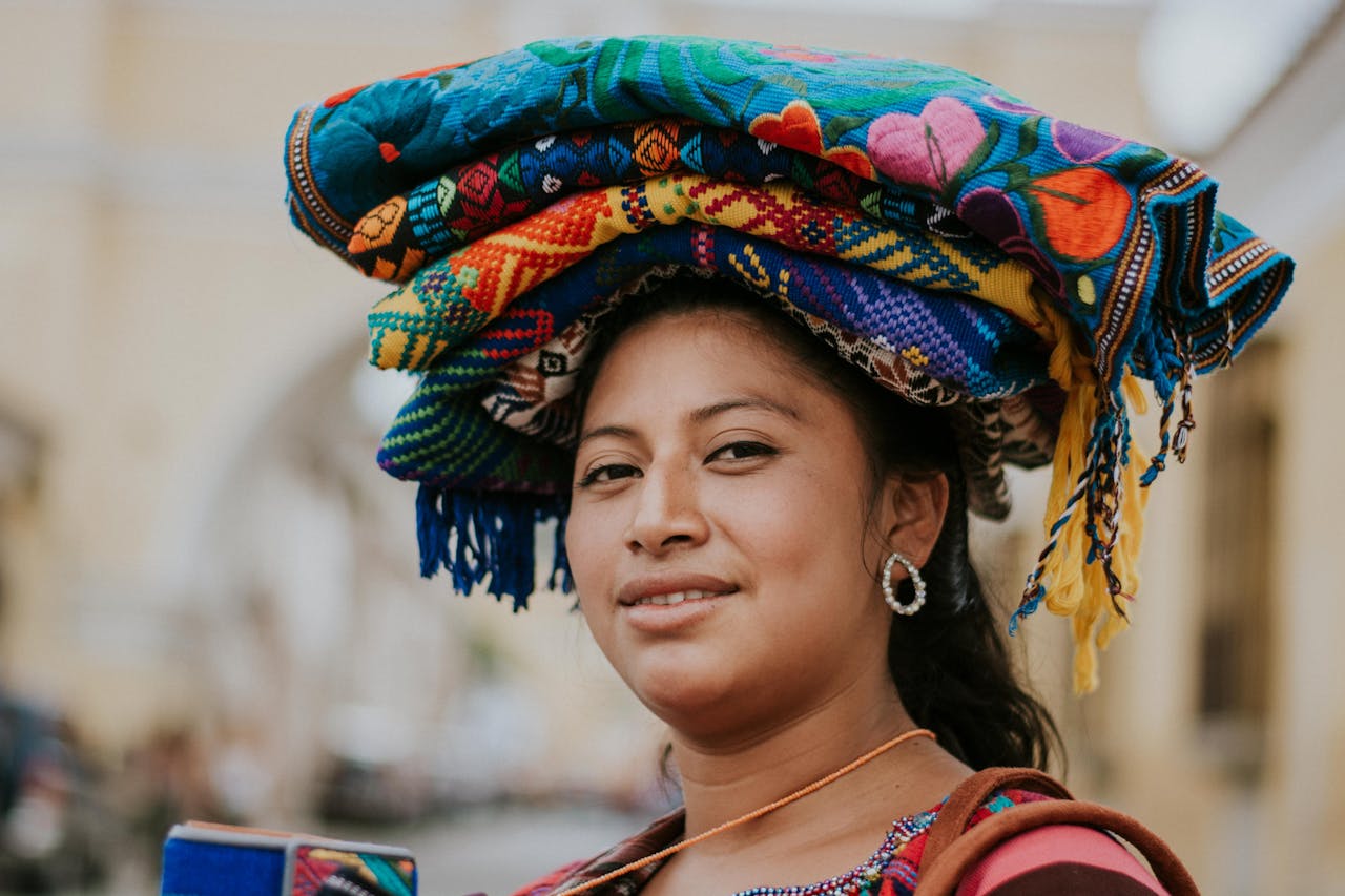 The Art of Drawing Readers In: Your attractive post title goes here Smiling woman in traditional clothing in Antigua, Guatemala.